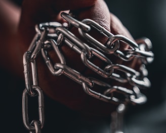 person holding silver chain link