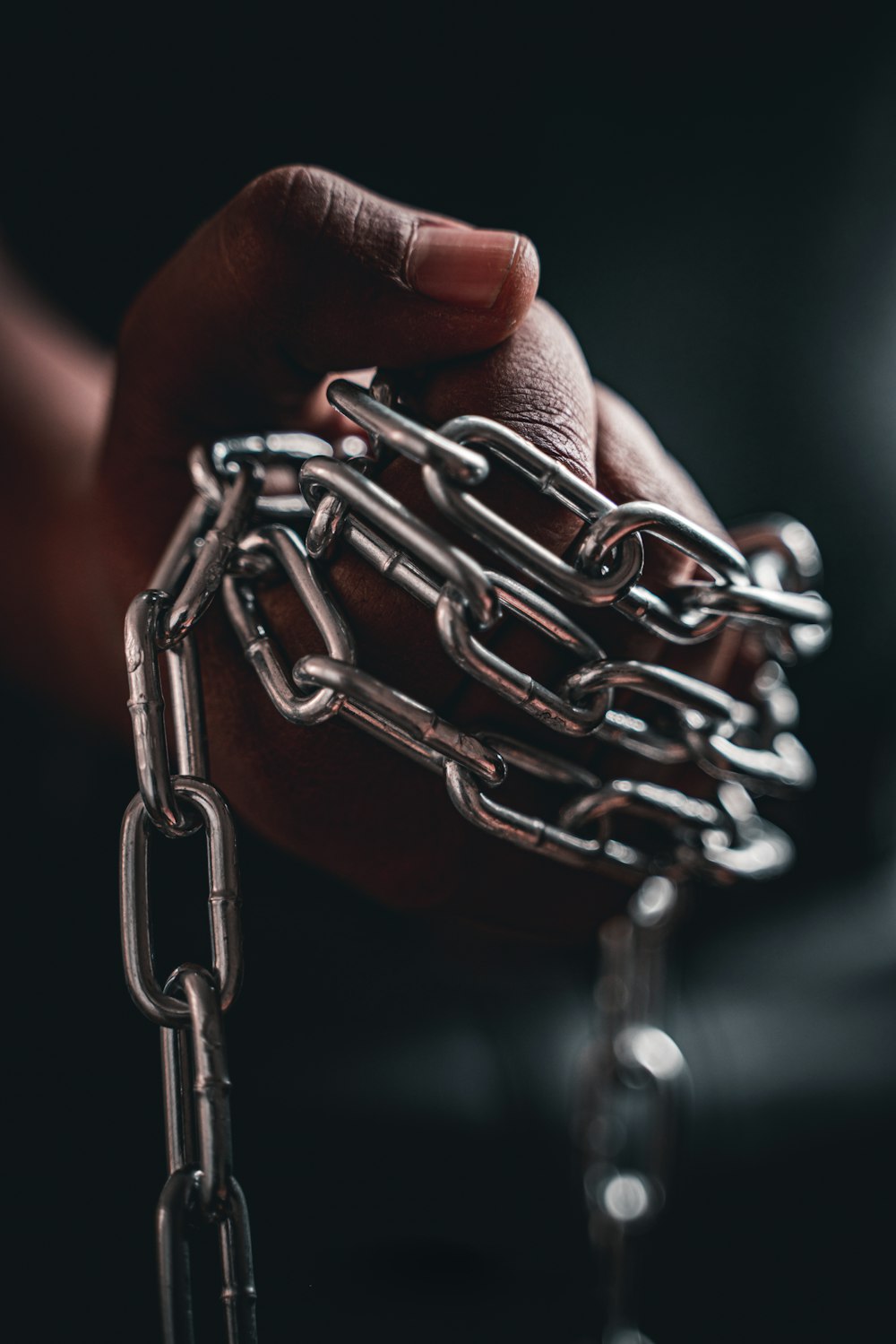 person holding silver chain link