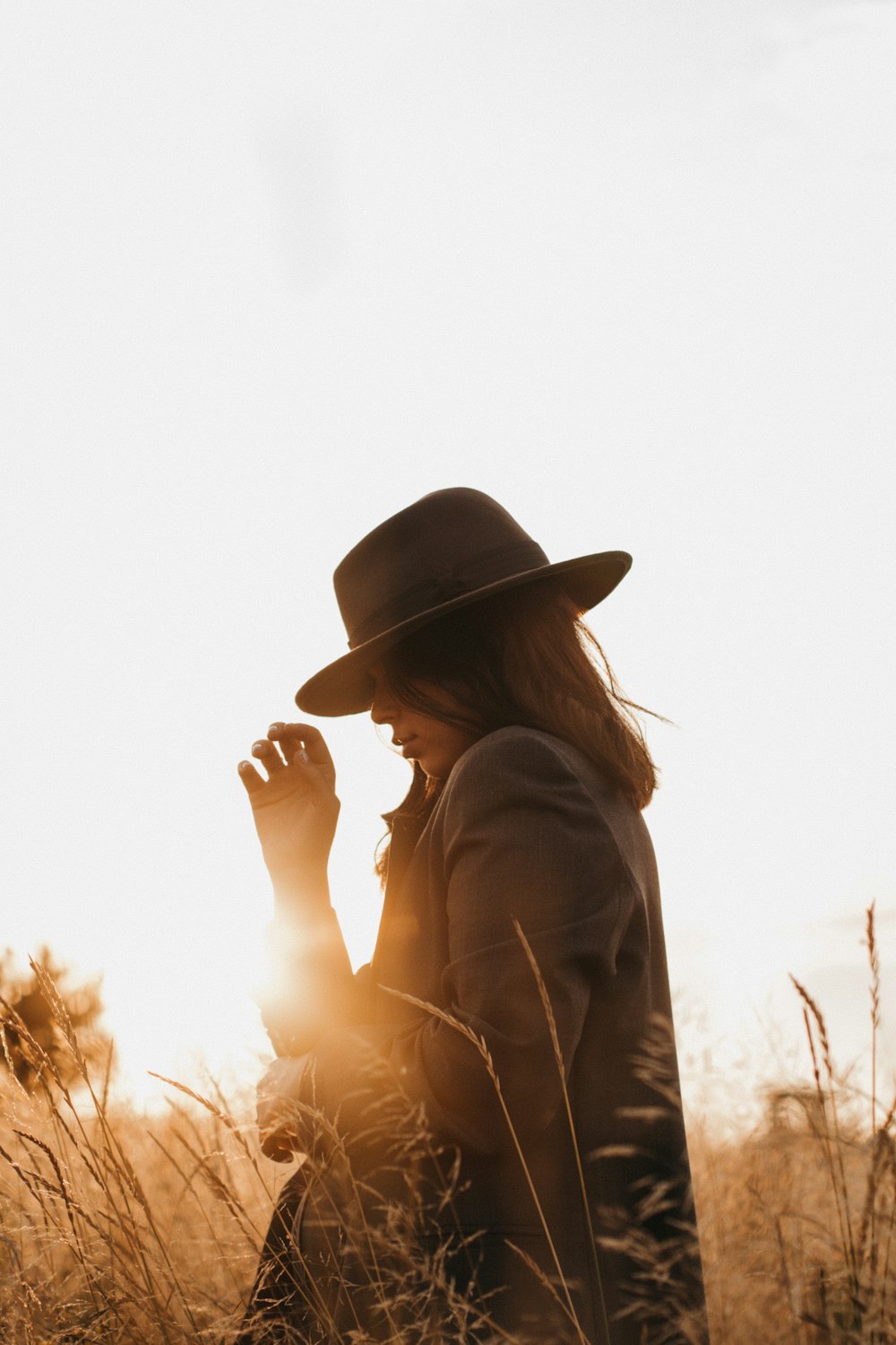 woman in brown hat and brown coat