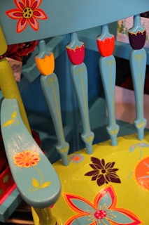 A beautifully restored wooden chair painted in soft mint green with lavender accents