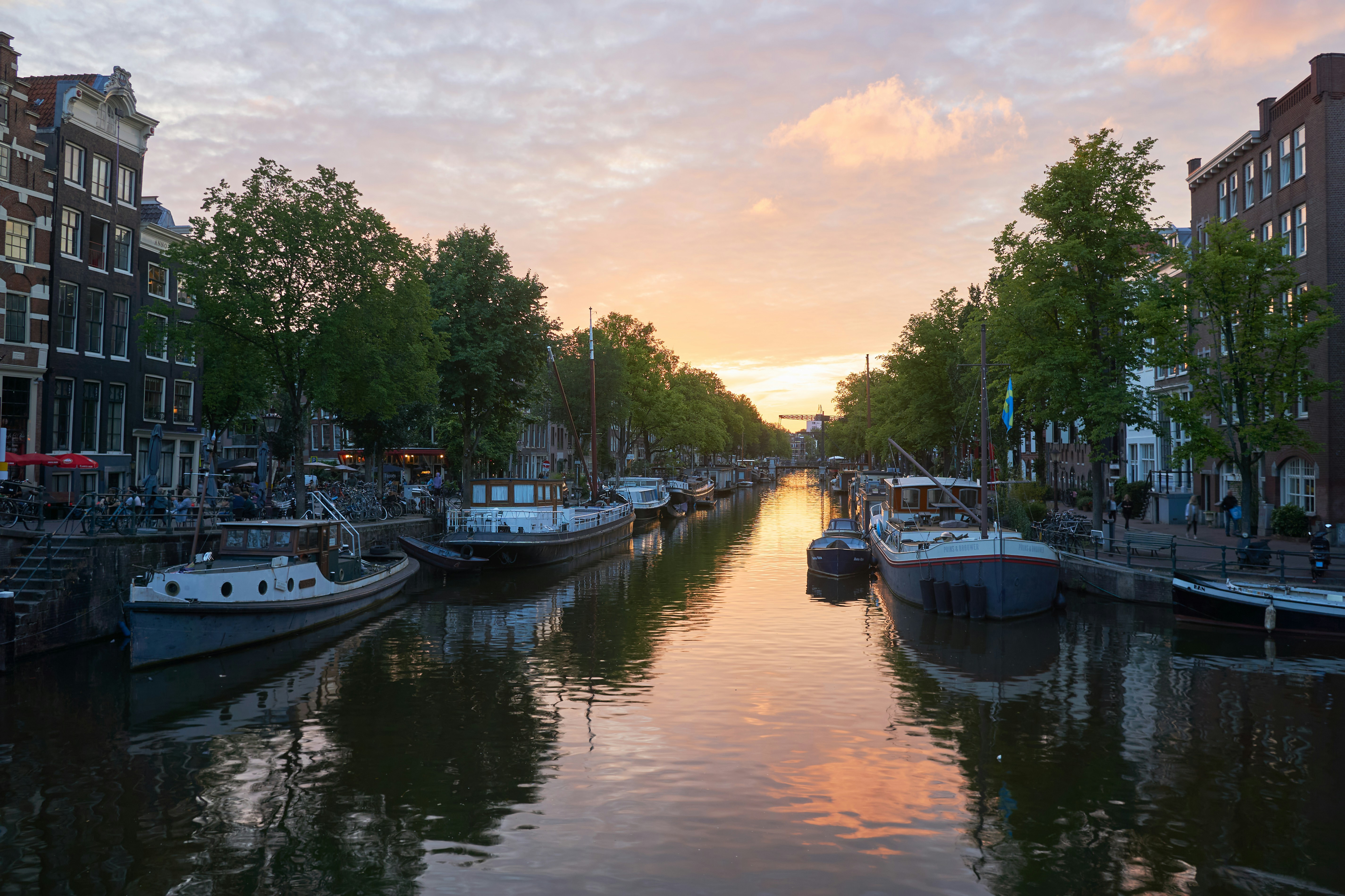 white and blue boat on river during daytime, Sunset in Amsterdam at a canal with boats