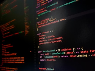 A computer screen displaying colorful lines of code primarily written in JavaScript. The background is dark with code highlighted in various colors like orange, green, and red to differentiate syntax elements.