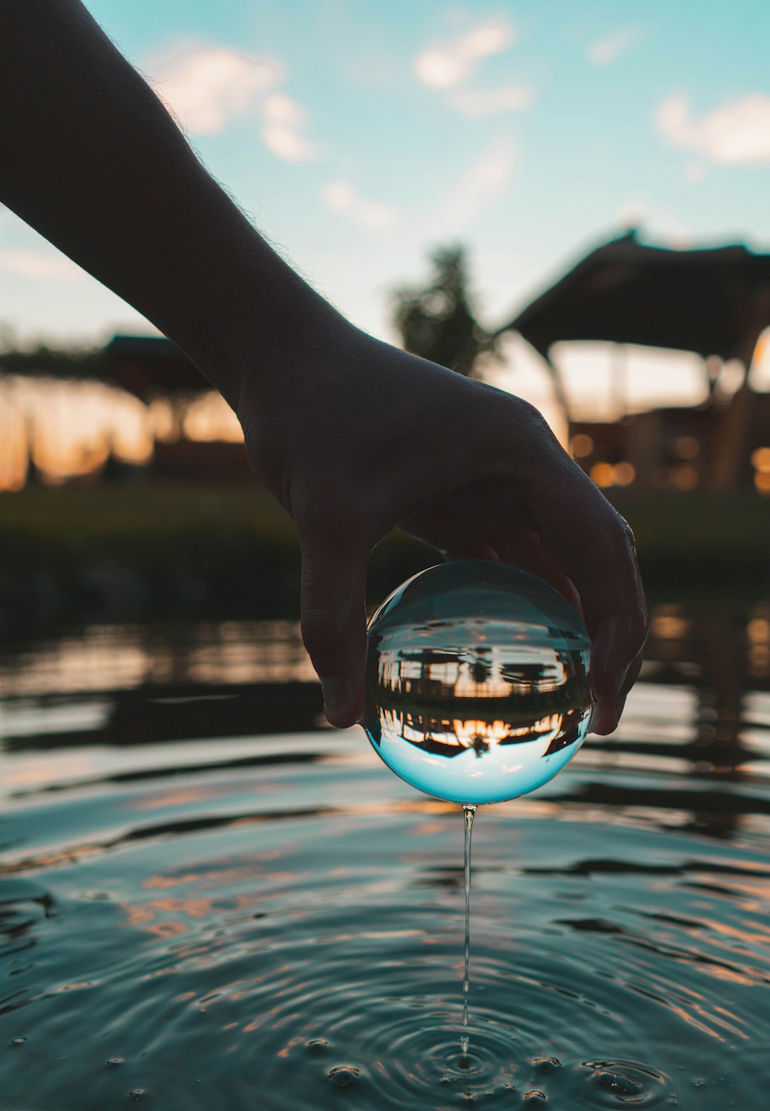 person holding clear glass ball