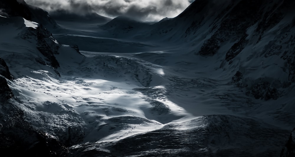 snow covered mountain under cloudy sky during daytime