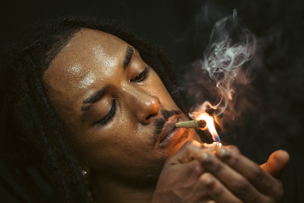 man smoking cigarette in close up photography