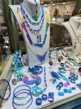 Display of colorful ethnic accessories including brooches, cufflinks, and pocket squares.