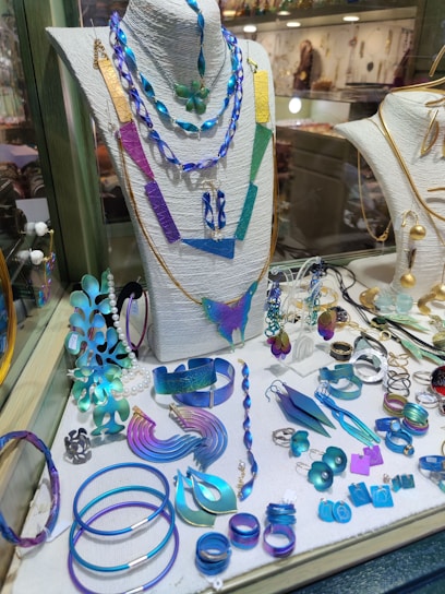 A vibrant display of colorful handcrafted jewelry pieces inspired by the earth and sun.