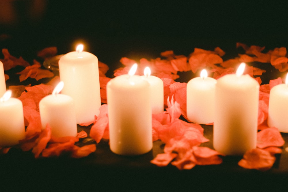 white candles on black surface