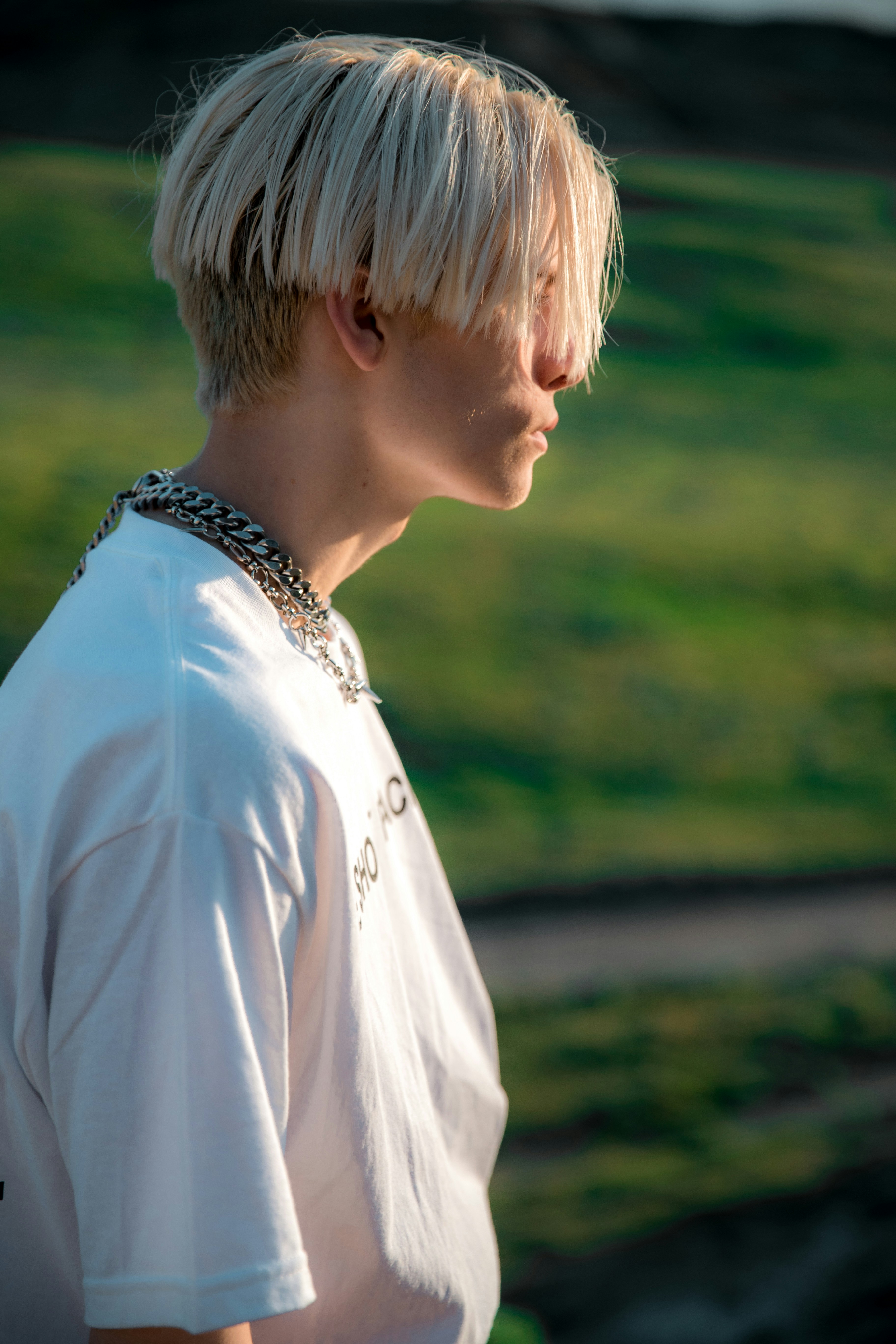 a young man with a bowl hair cut in platinum blonde