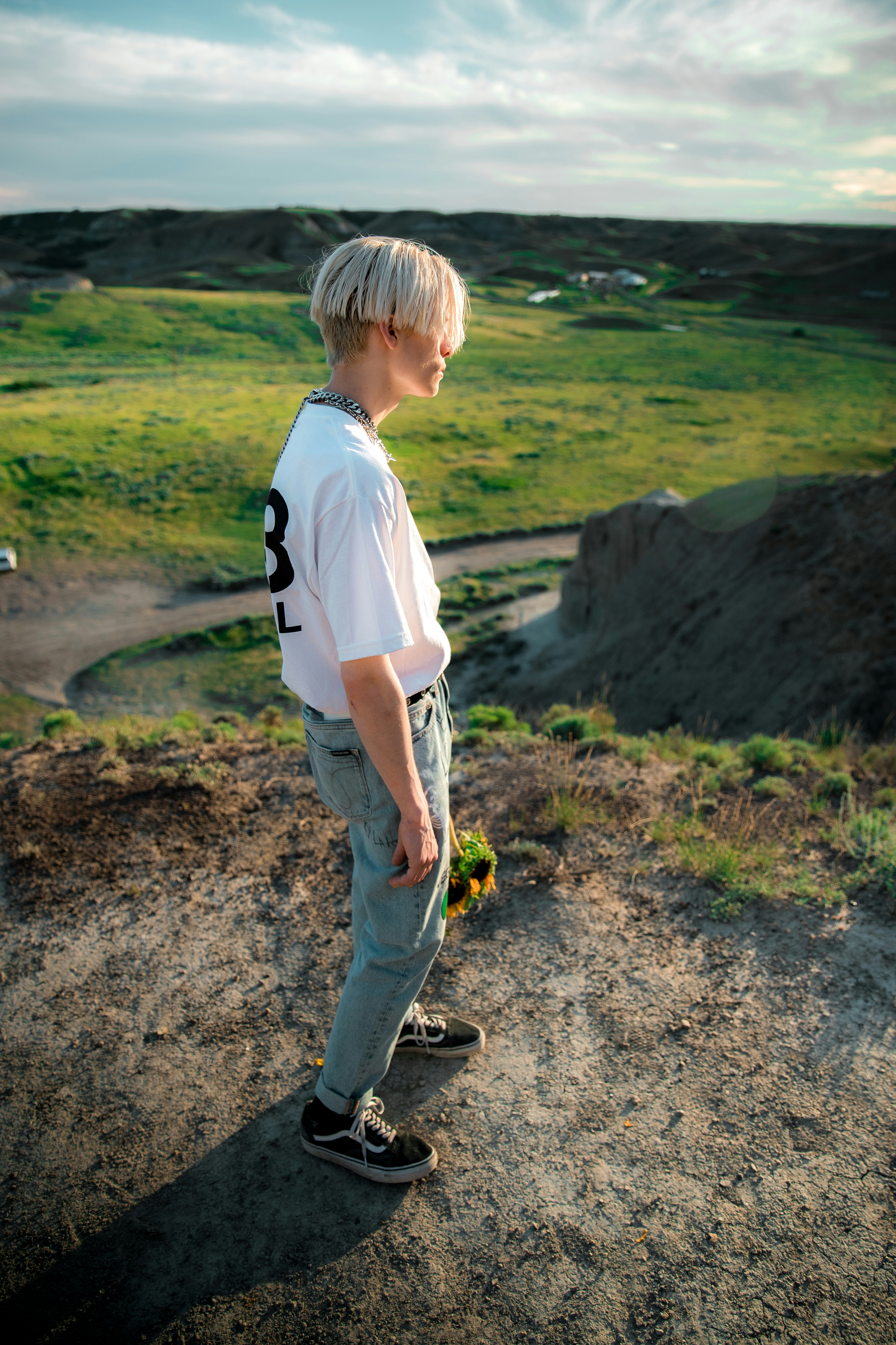 Child with a small field guide observing tide pools with a parent nearby