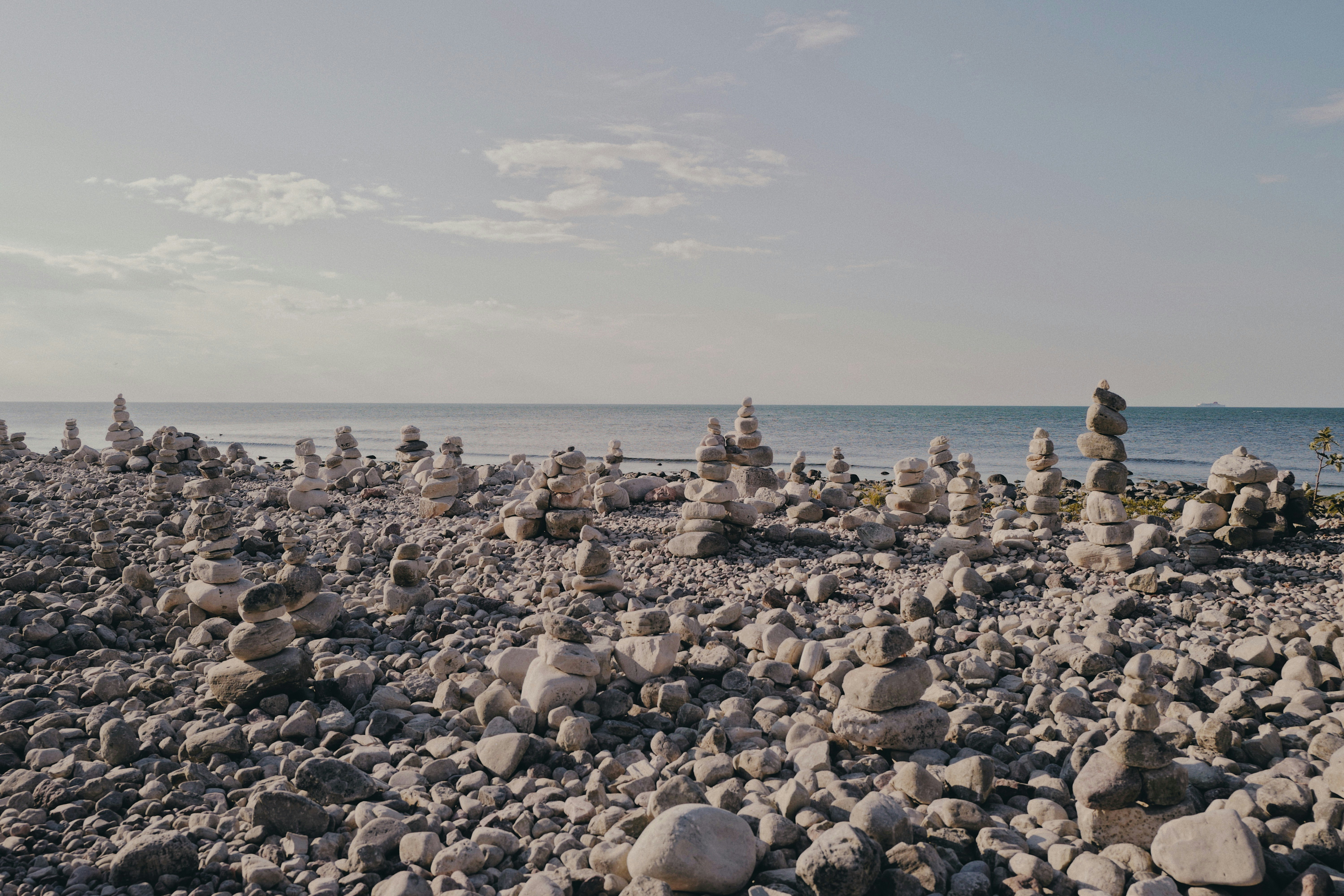 gray and brown rocks near body of water during daytime