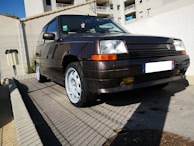 A compact hatchback parked near a beach.