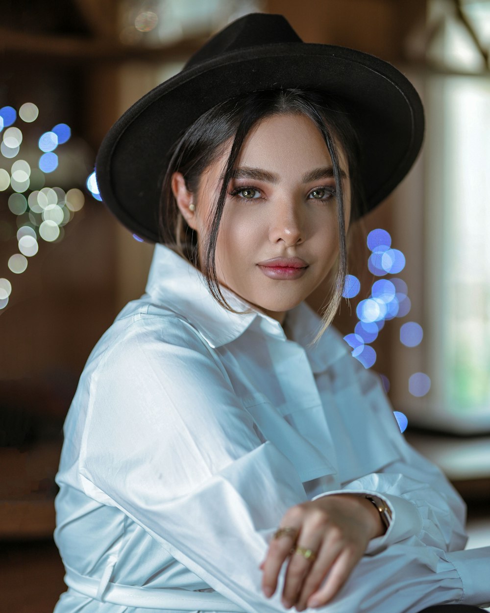 woman in white dress shirt wearing black hat