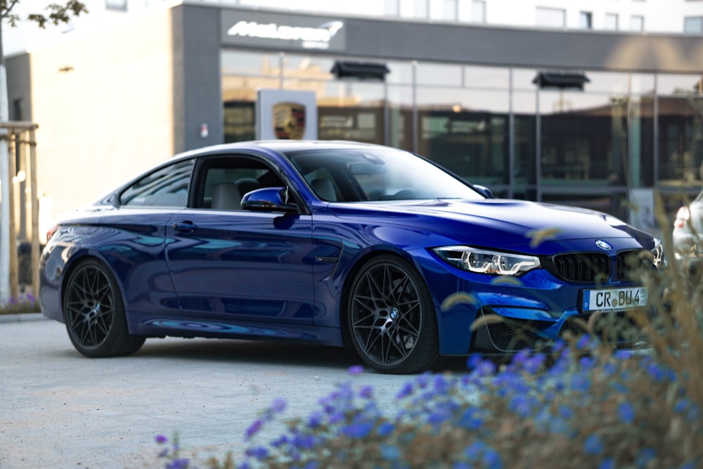 blue bmw m 3 coupe parked on parking lot during daytime