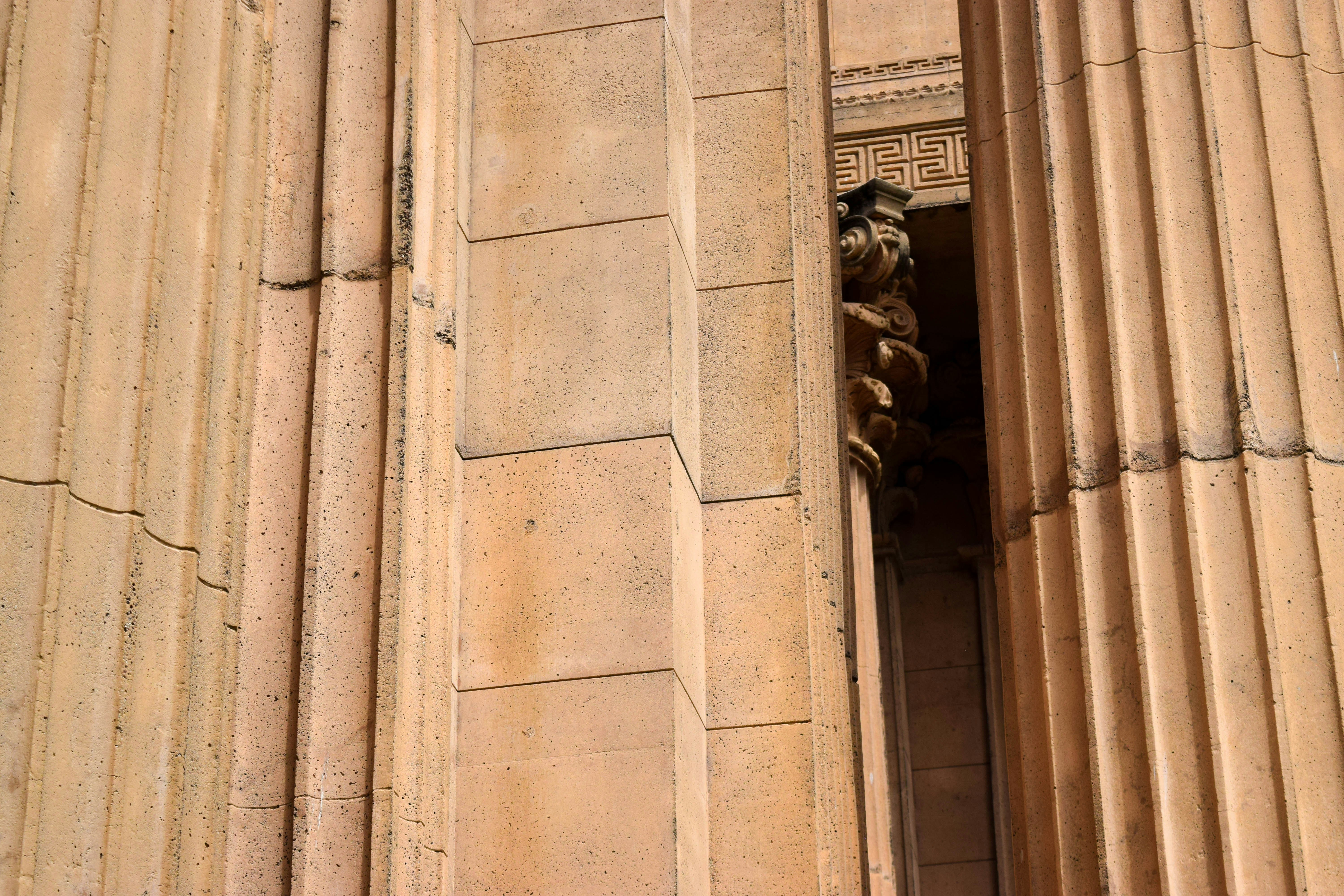 brown concrete building with human statues