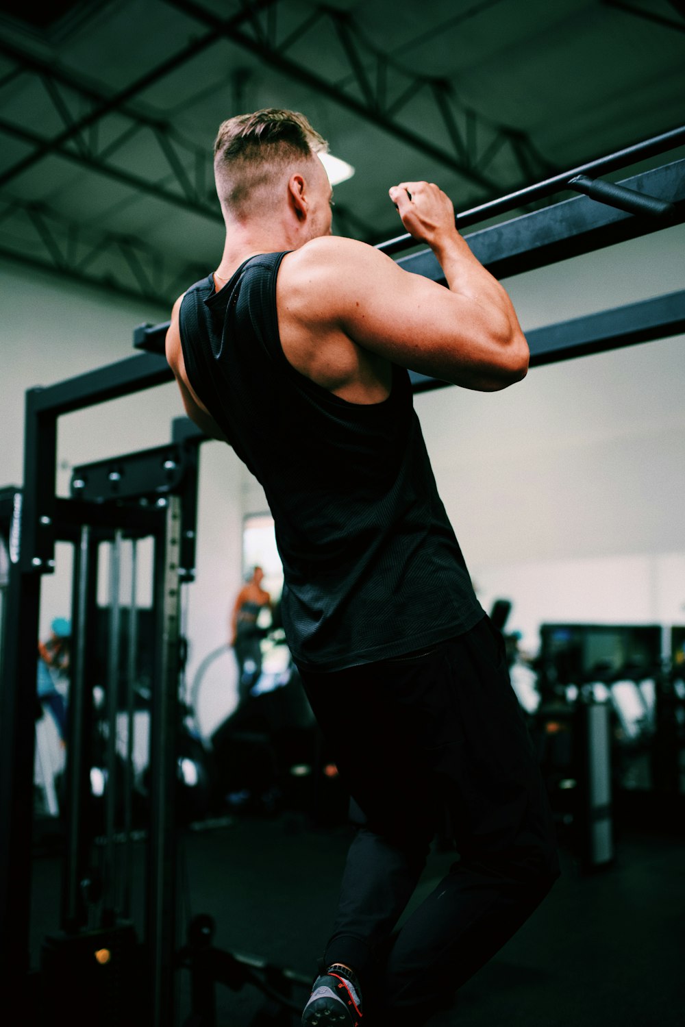 man in black tank top and black pants