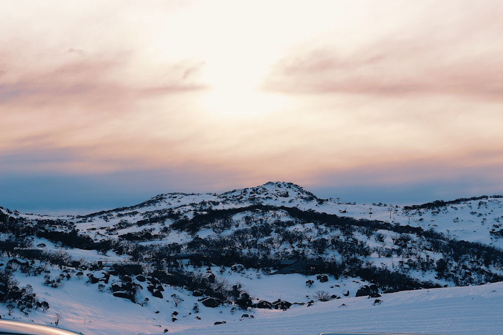 snow covered mountain under cloudy sky during daytime