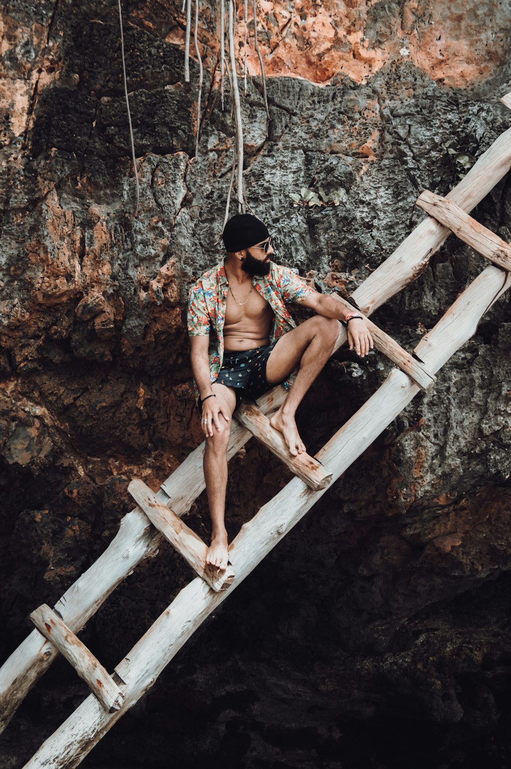 woman in black bikini sitting on brown wooden ladder