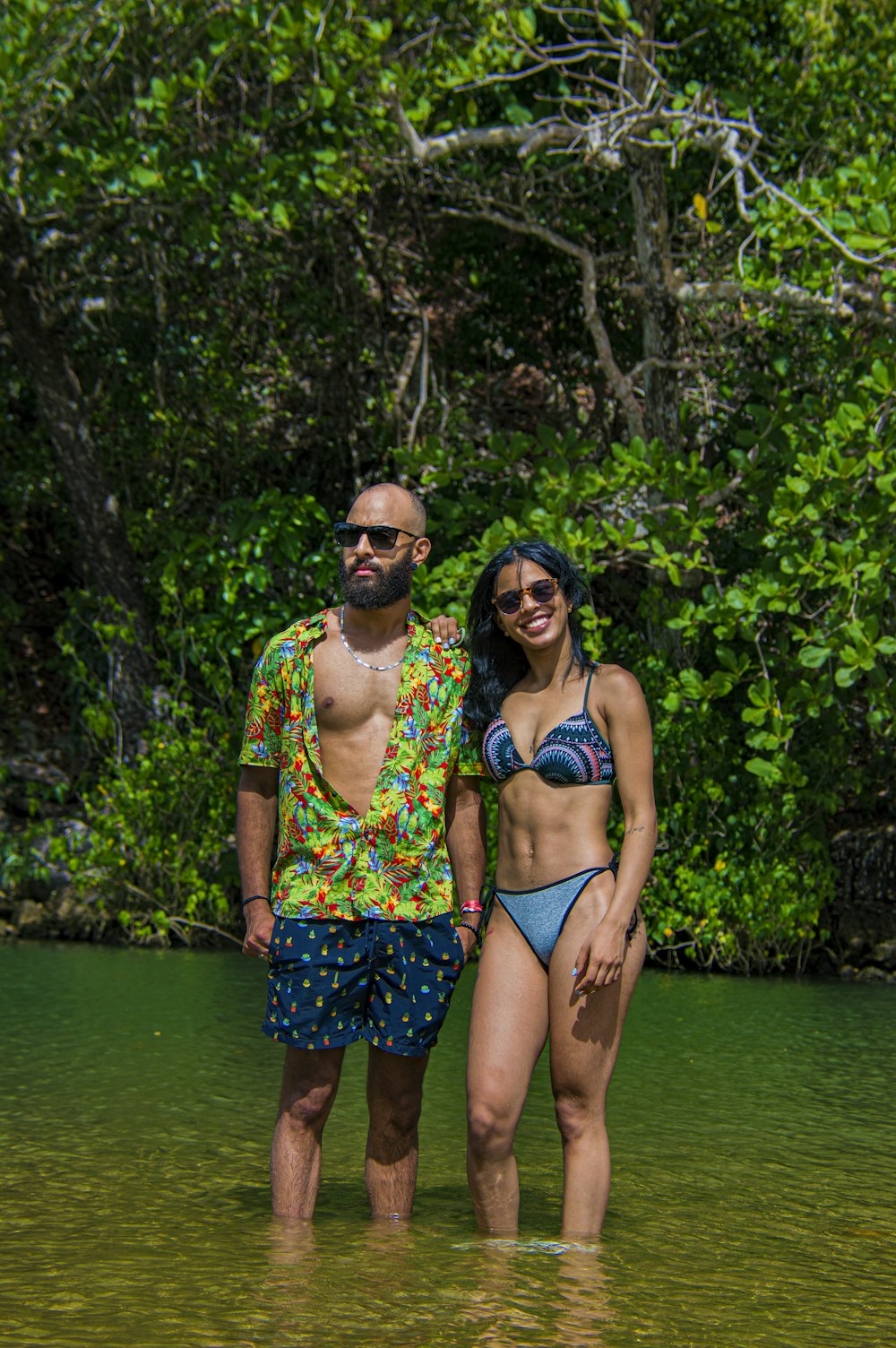 woman in blue and white floral bikini standing on water during daytime