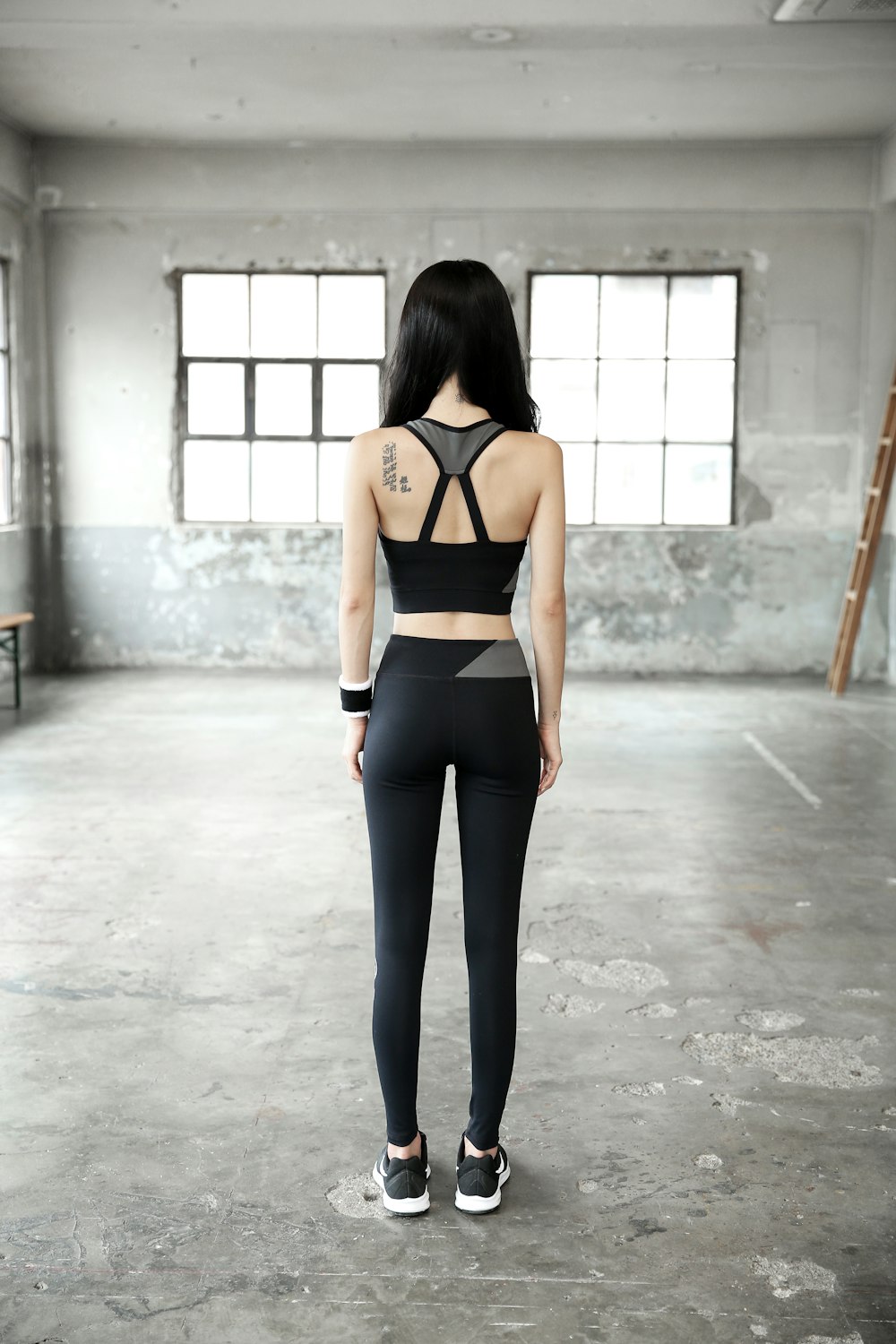 woman in black sports bra and black leggings