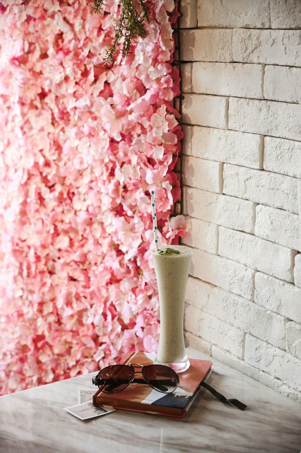 pink flowers in green ceramic vase