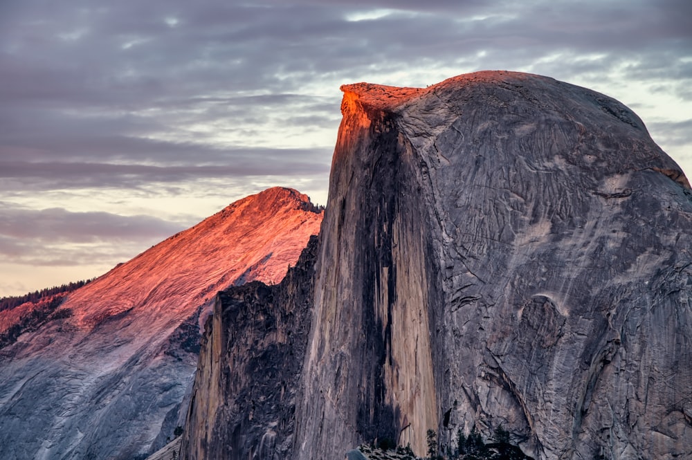 brown and gray rock formation under gray clouds