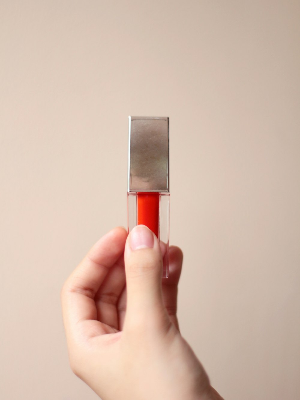 person holding silver and orange bar