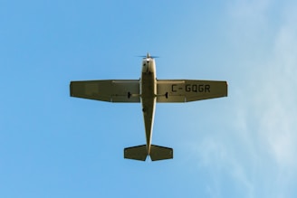 A small training aircraft on the runway with a clear blue sky.