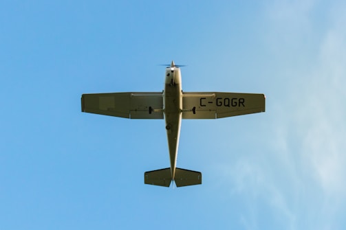 A small plane taking off against a clear blue sky.