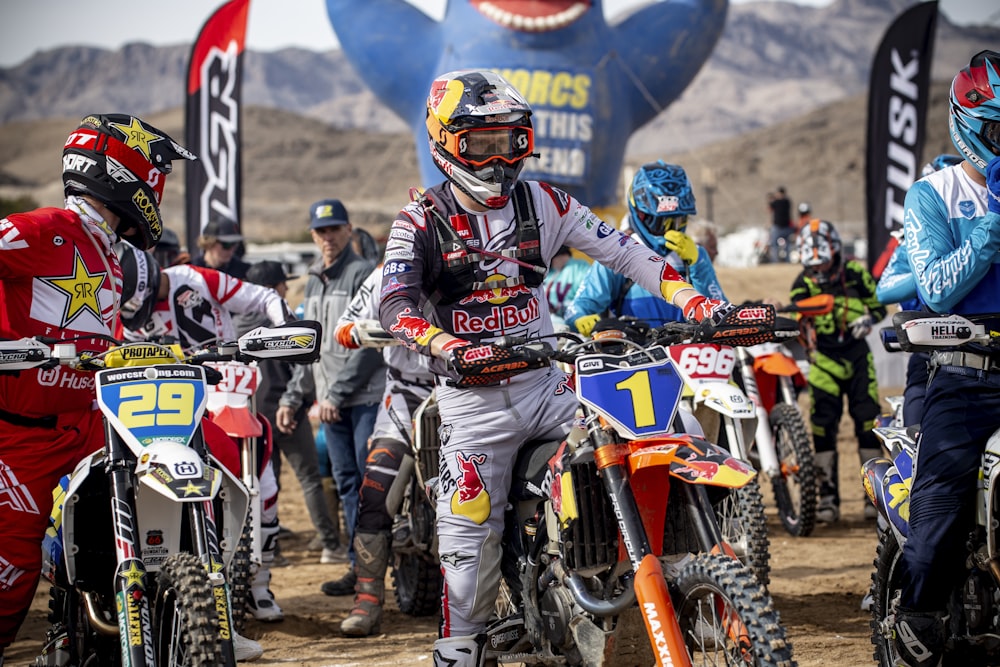 man in blue and orange motorcycle suit riding motocross dirt bike