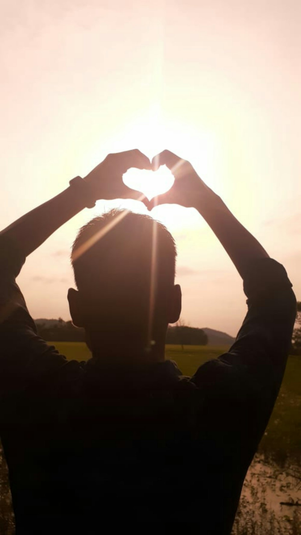 silhouette of person raising hands