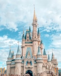 white and blue castle under blue sky and white clouds during daytime