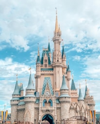 white and blue castle under blue sky and white clouds during daytime