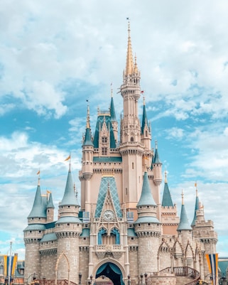 white and blue castle under blue sky and white clouds during daytime