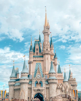 white and blue castle under blue sky and white clouds during daytime