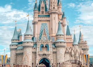 white and blue castle under blue sky and white clouds during daytime