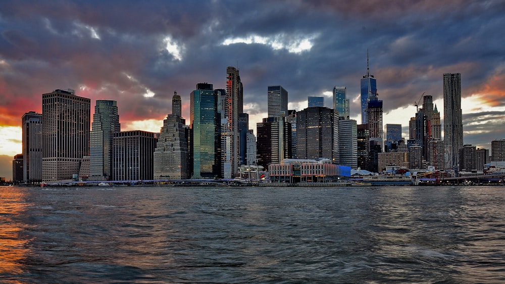 city skyline across body of water during daytime