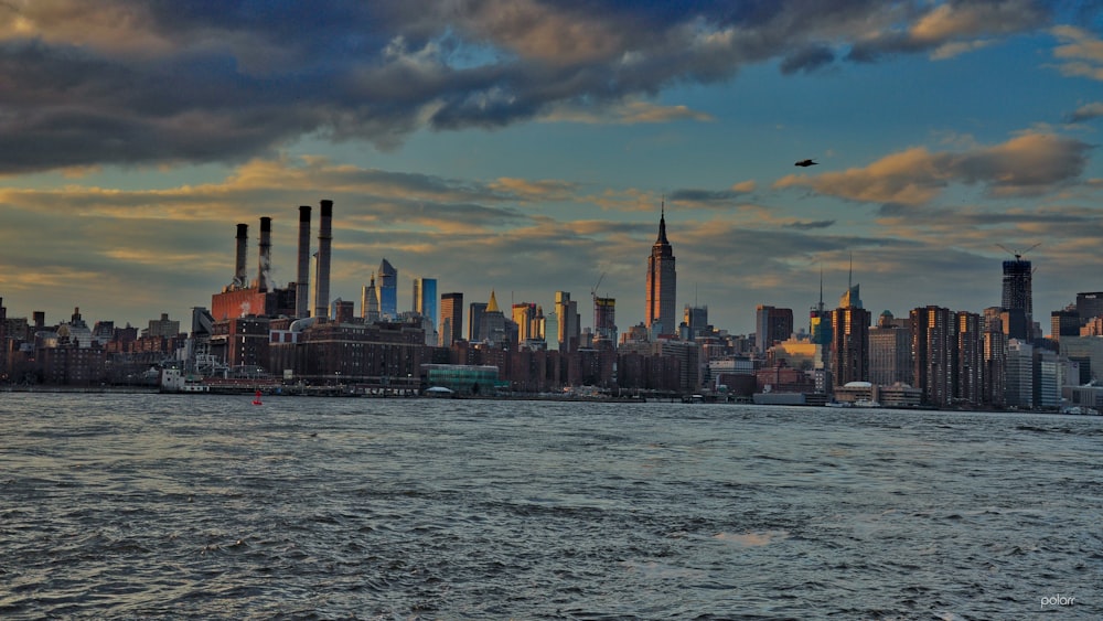 city skyline under blue and white cloudy sky during daytime