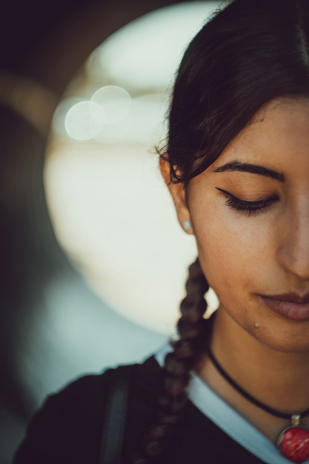 woman in black shirt wearing silver necklace