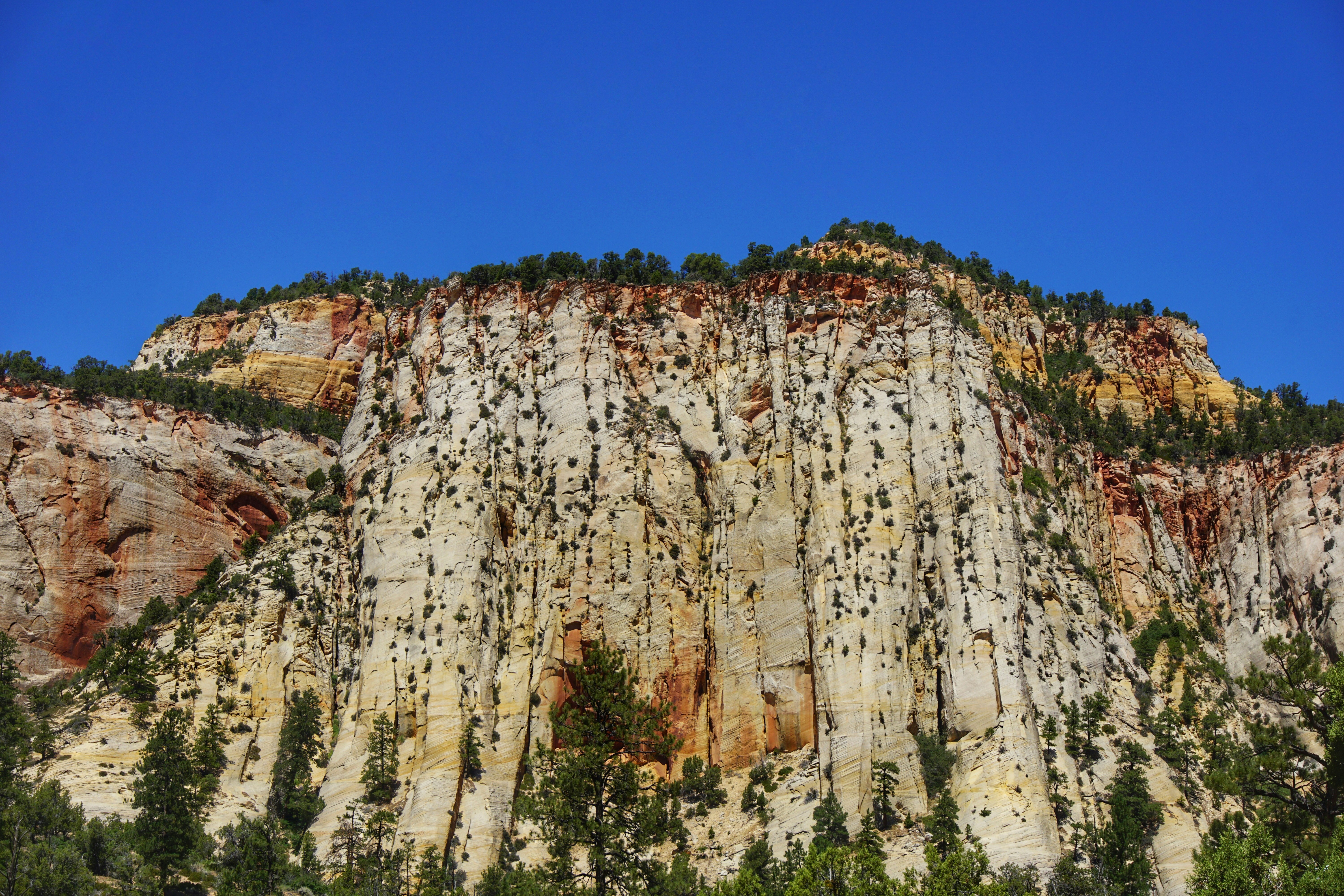 brown rocky mountain under blue sky during daytime