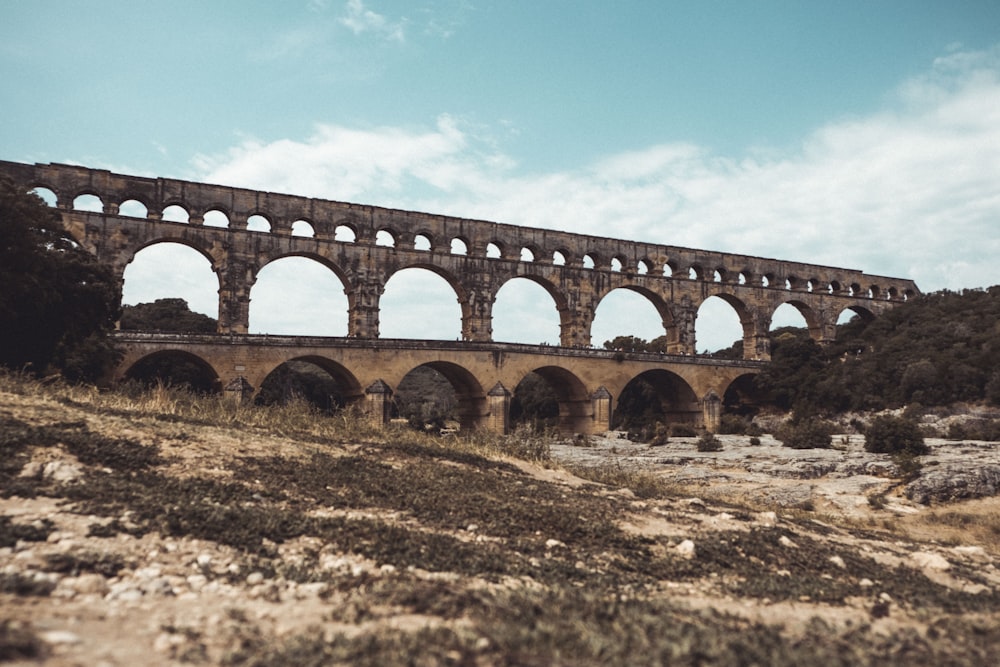 brown concrete bridge under blue sky during daytime