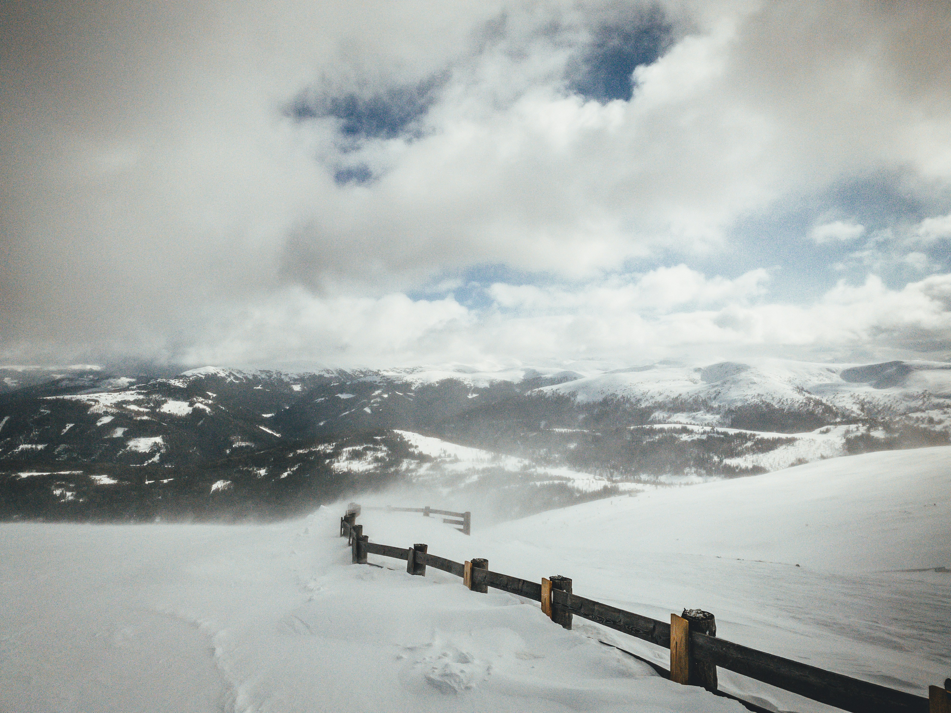 snow covered mountain under cloudy sky during daytime