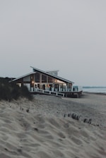 brown wooden house on beach during daytime