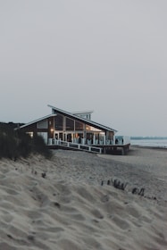 brown wooden house on beach during daytime