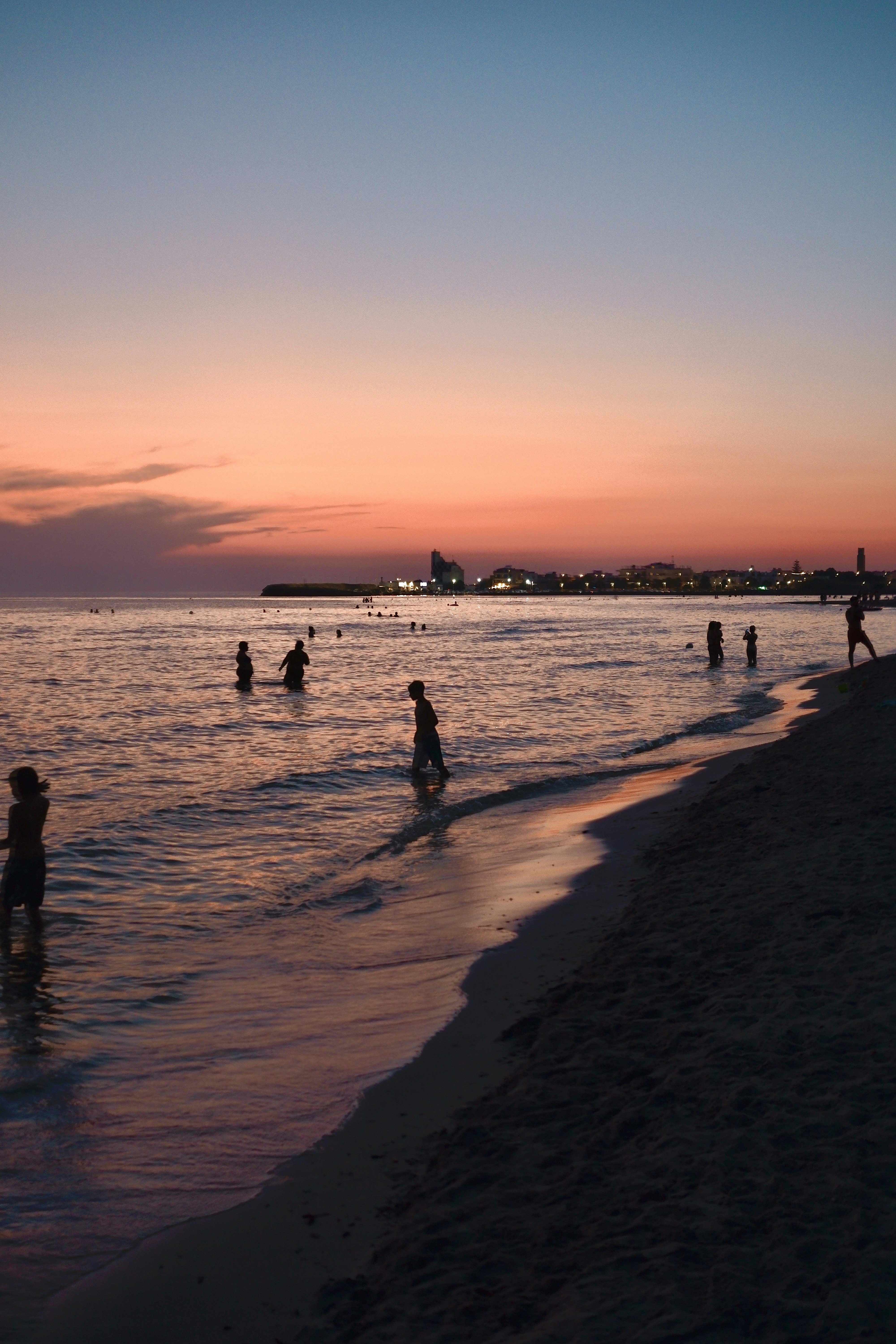 people on beach during sunset