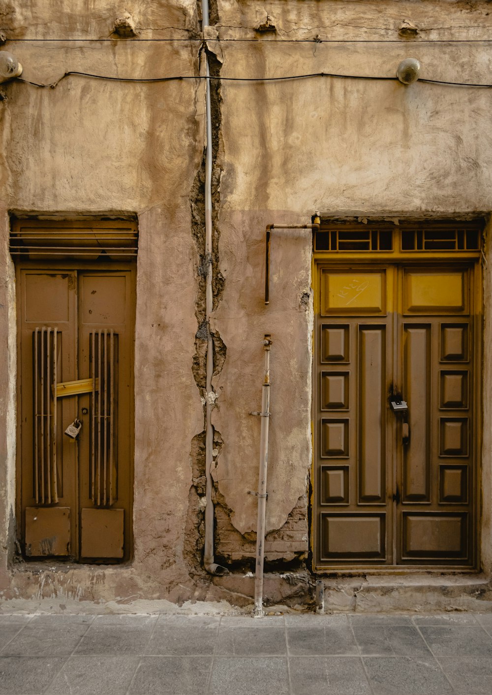 brown wooden door with white metal chain