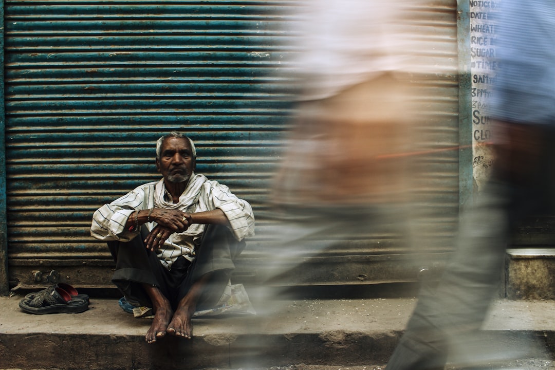 man in white dress shirt sitting on floor