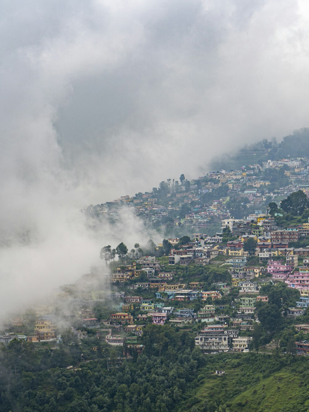 city with high rise buildings covered with white clouds during daytime