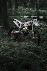 red and black sports bike on green grass field