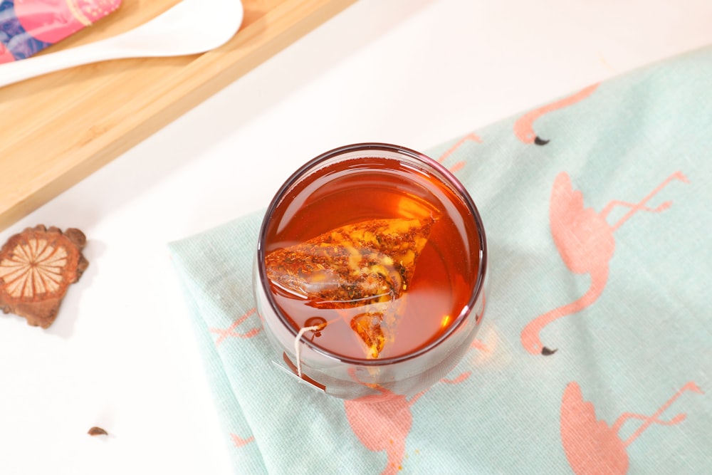 brown liquid in clear glass bowl